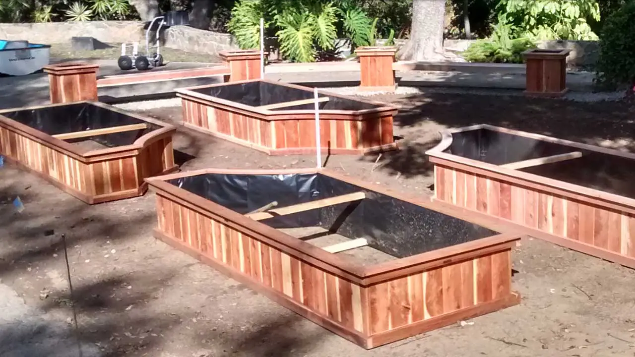 A wooden planter box with two different sizes.