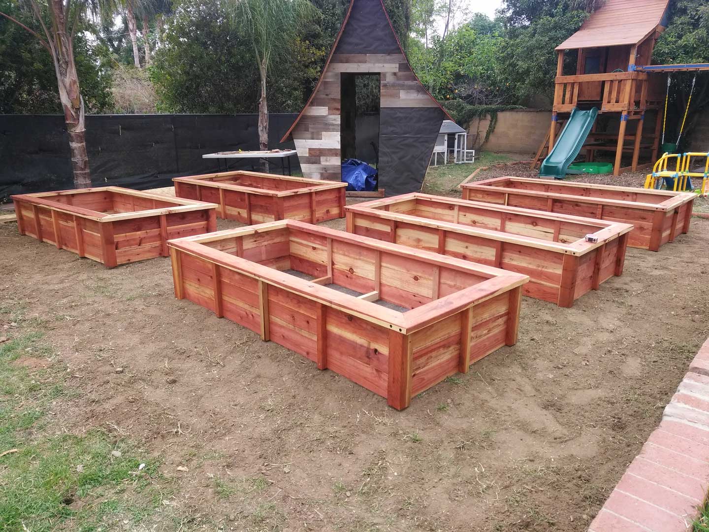 A group of wooden boxes in the dirt.