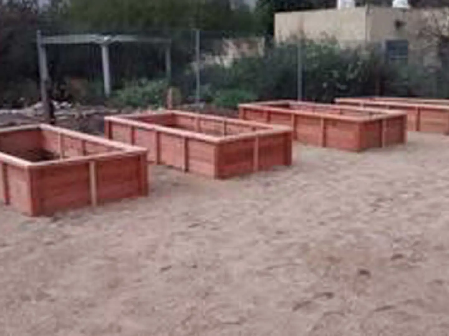A group of wooden boxes in the sand.