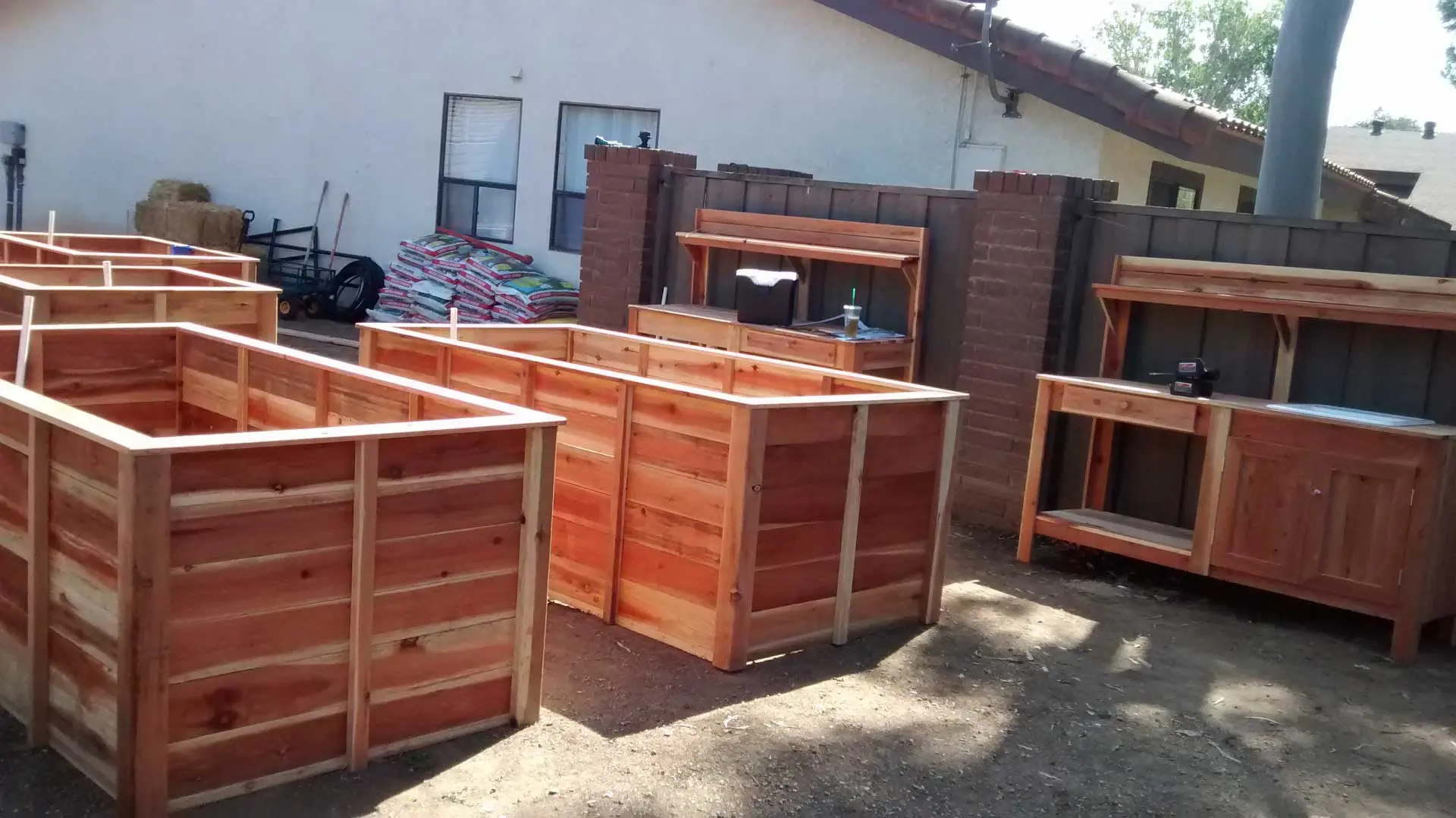 A set of wooden boxes in a backyard.