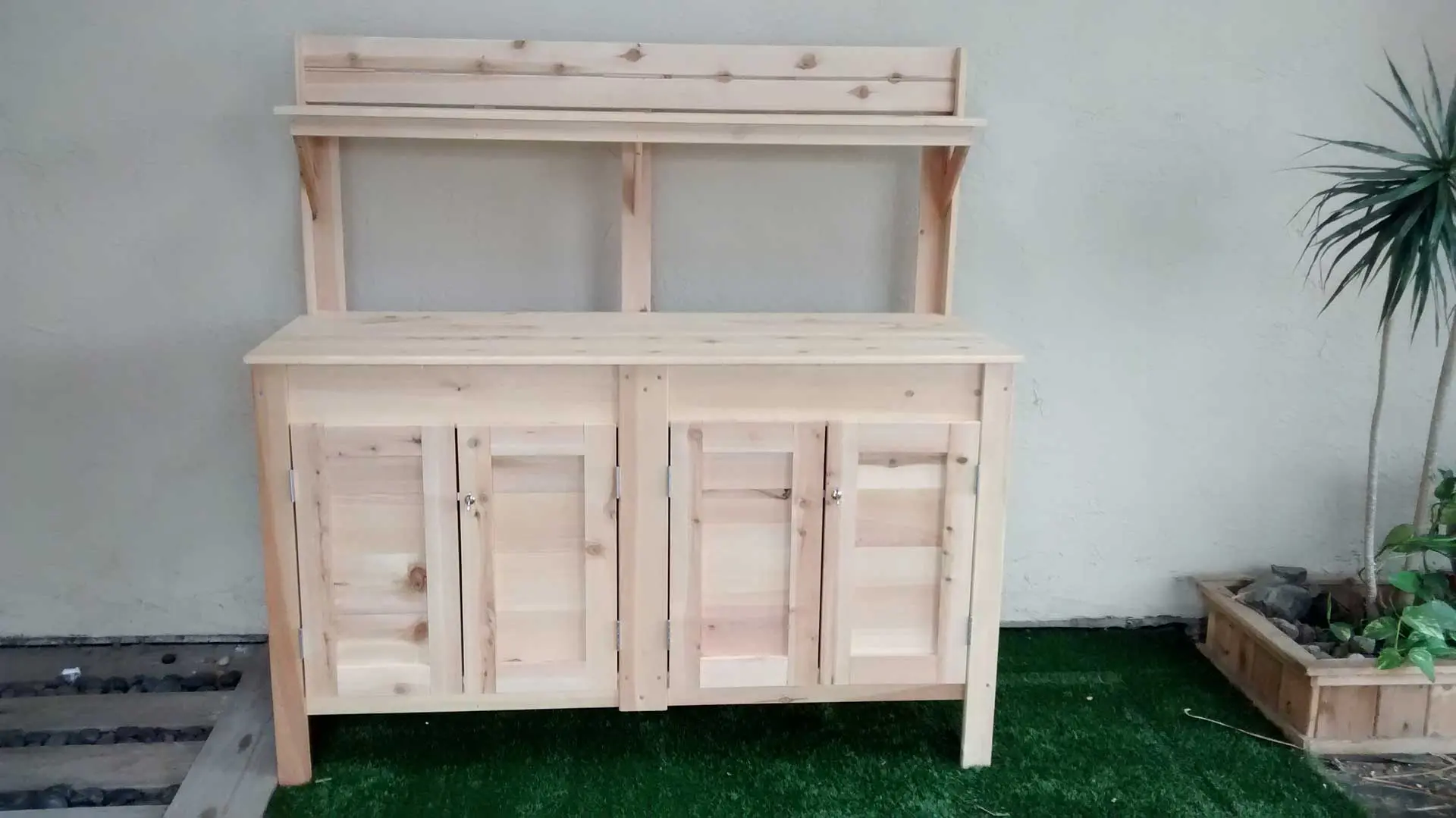 A wooden cabinet with two doors and one shelf.