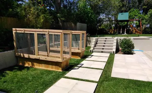 A backyard with a raised garden bed and steps.