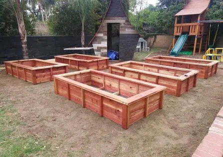 A set of raised garden beds in a backyard.