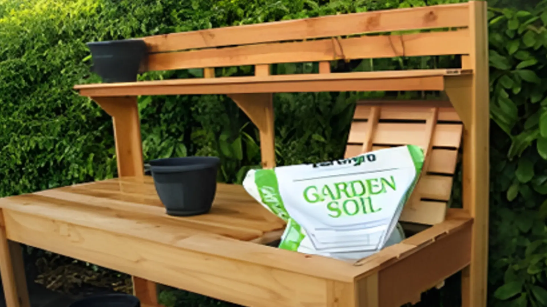 A wooden bench with garden soil on it.